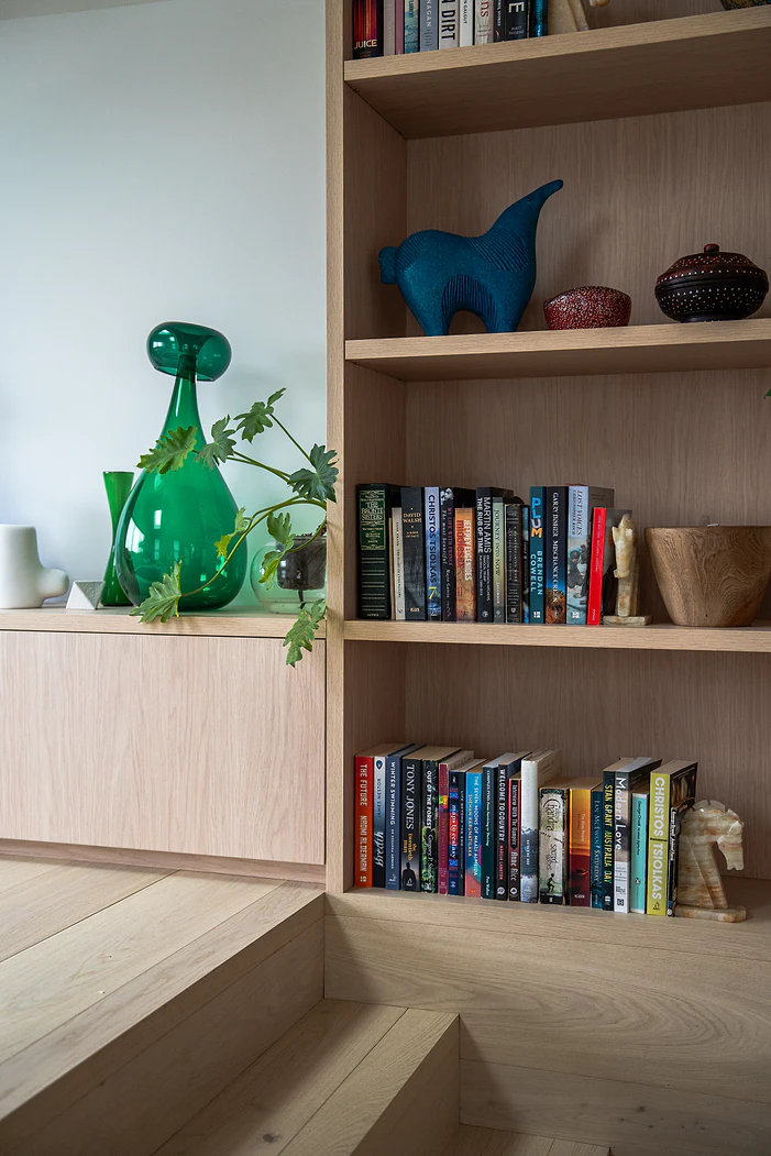 Custom timber bookshelf with open shelving and storage cupboards