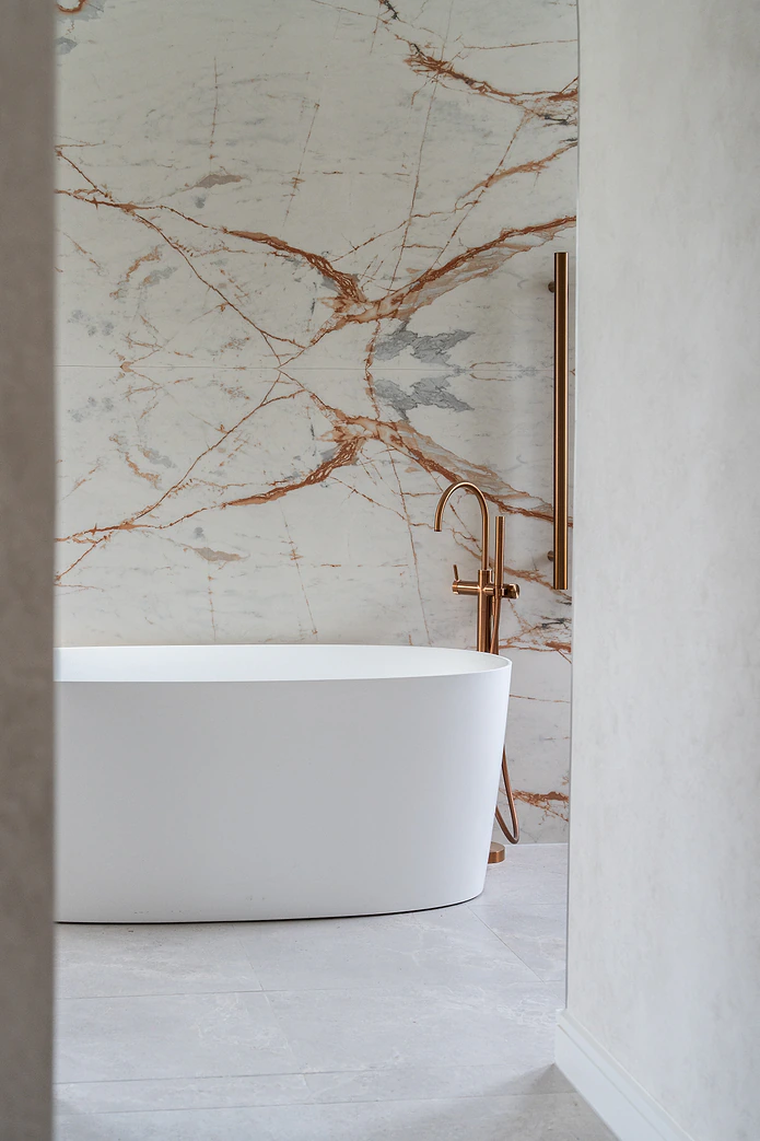 Ensuite with marble feature wall and freestanding bath