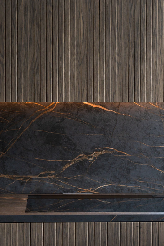 Detail of fluted timber panelling and dark stone splashback