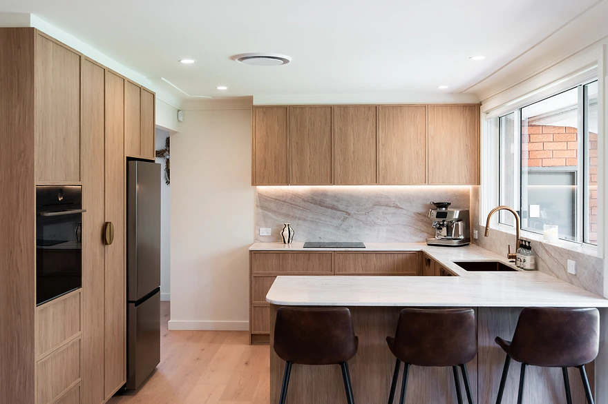 Timber U-shaped kitchen with stone benchtops and breakfast bar