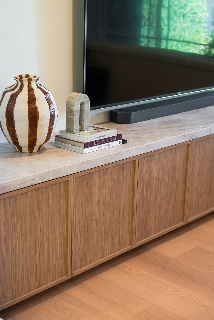 Timber TV cabinet with stone top in a living room