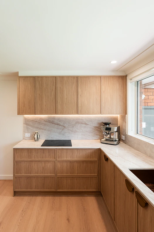 Timber kitchen with marble splashback and under-cabinet lighting