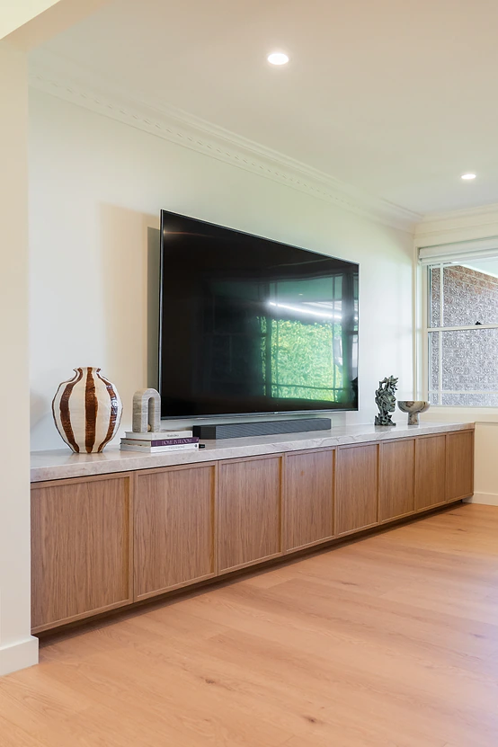 Wall mounted TV above a custom timber entertainment unit
