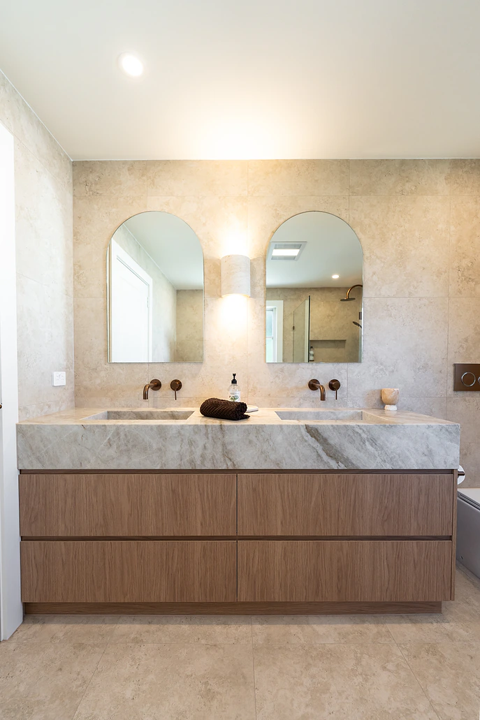 Double timber vanity with stone top and arched mirrors